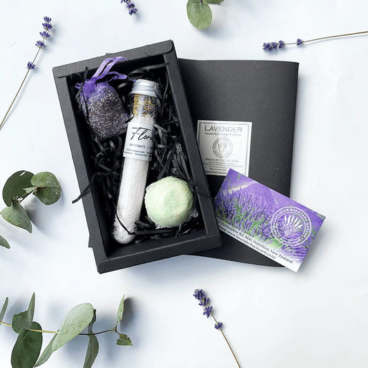 Amazing Bath Spa Gift Sets with lavender sachet, bath bomb, and bath salts scented by essential oil, surrounded by dried flowers and foliage.