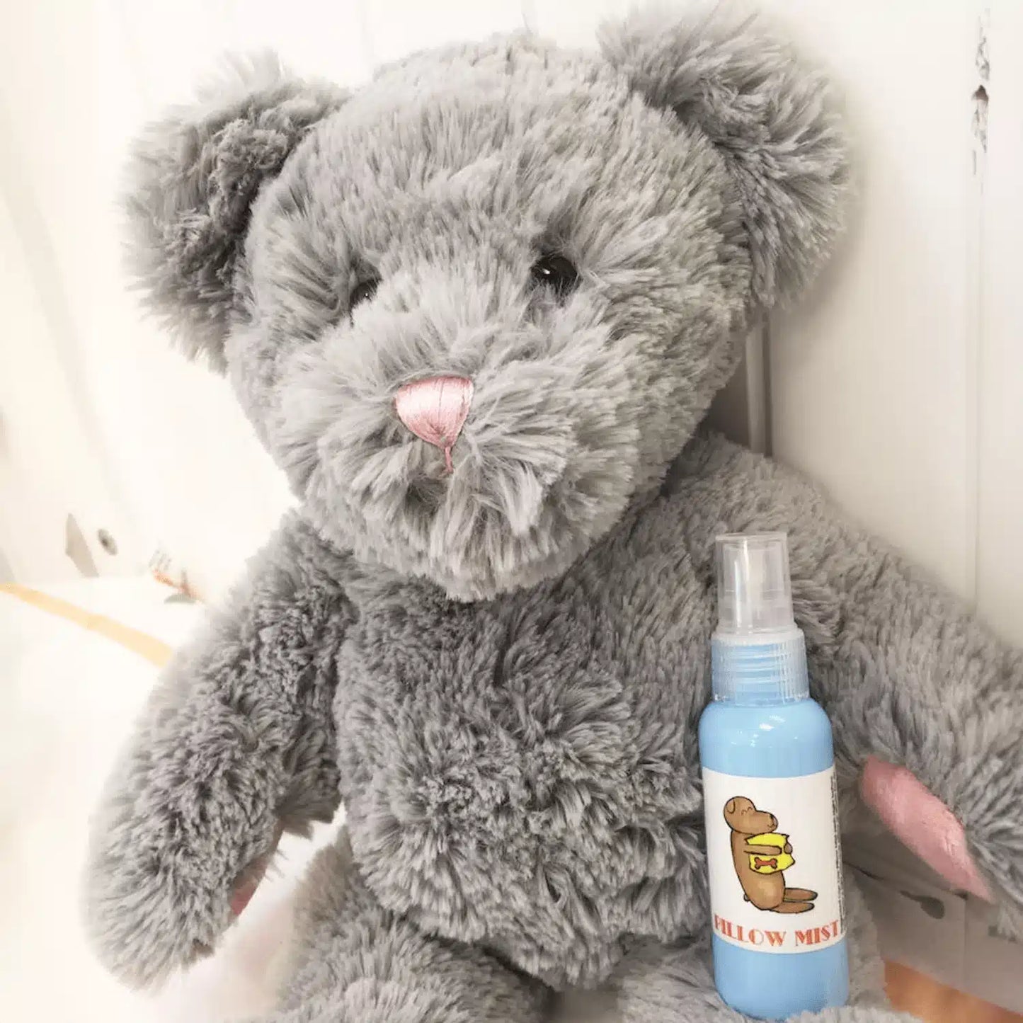 Kids Lavender Sleep Mist for Restful Sleep, placed against a soft toy bear for a cozy and comforting display.