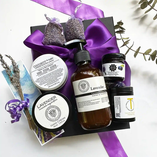 Tea Time Therapy Gardening Gift Set for Her wrapped in a purple ribbon black gift box, includes Lavender Hand Cream for Dry Hands, Lavender Hand Sugar Scrub, Therapy Lavender Hand Wash, two Dried Lavender Sachets,Lavender Chamomile Tea, Blueberry Lavender Jams, Mini Dried Lavender Flowers, and a Lavender Field Bookmark.