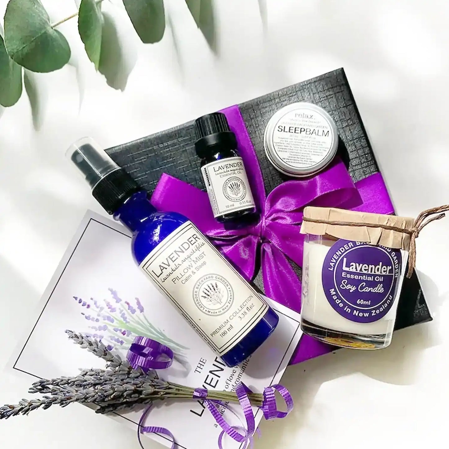 Aromatherapy gift set featuring a lavender soy candle, sleep balm, pure lavender essential oils, pillow mist, and a lavender-themed greeting card, designed to promote relaxation and better sleep.