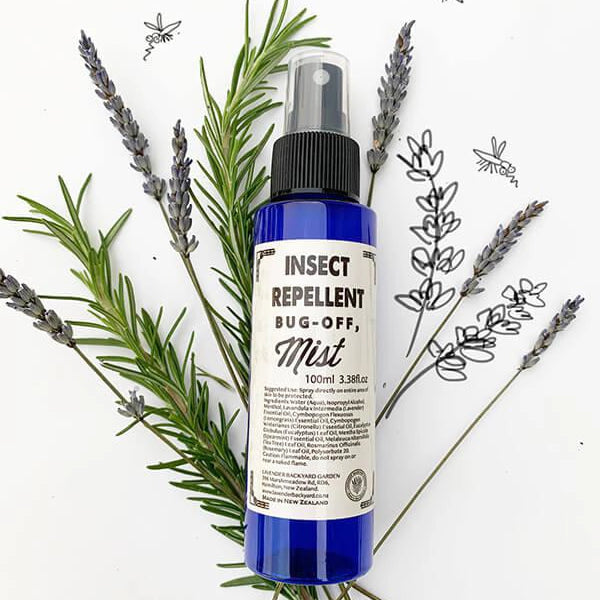 Close-up view of the best mosquito repellent spray, scented by essential oils, with a background of rosemary and dried lavender flowers, showcasing its natural ingredients.