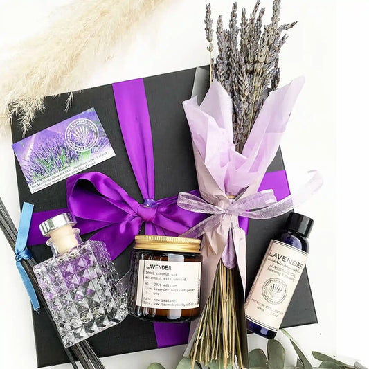 Best Yoga & Meditation Gift Set for Women featuring a lavender coconut wax essential oil candle, lavender massage oil, lavender essential oils reed diffuser, and a dried lavender bouquet.