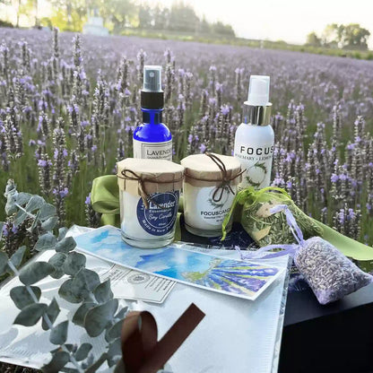 Calming Sleep Gift Set for Him, Husband, or Dad against a purple lavender field, featuring products including Lavender Essential Oil Pillow Mist, Focus Aromatherapy Spray, Sleeps Well Lavender Pillow Sachet, Dried Lavender Sachet, Eucalyptus, Rosemary & Lavender Sachet, Lavender Votive Soy Candle, Focus Lavender Rosemary Soy Candle, Small Dried Eucalyptus Bundle, and a Lavender Field Bookmark.