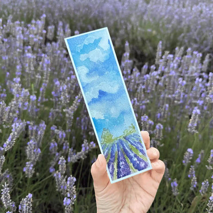 Close-up view of a lavender field bookmark, featuring a hand-drawn design of lavender fields, with a soft blurred background of blooming lavender flowers at Lavender Backyard Garden, NZ.