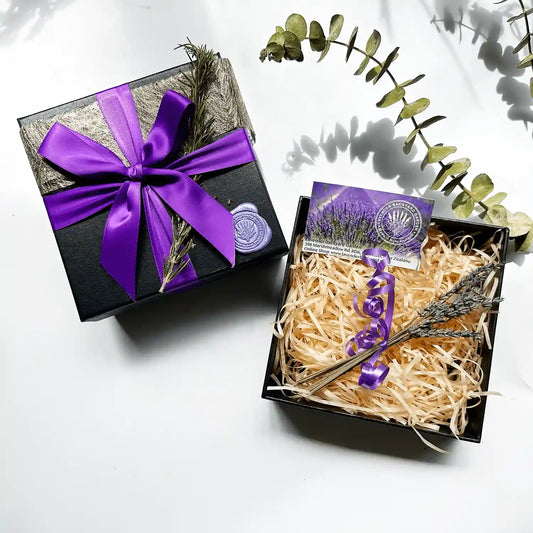 Build your own gift box featuring an empty black gift box with a purple ribbon and mini dried lavender flowers, ready to be personalized with your choice of gifts.