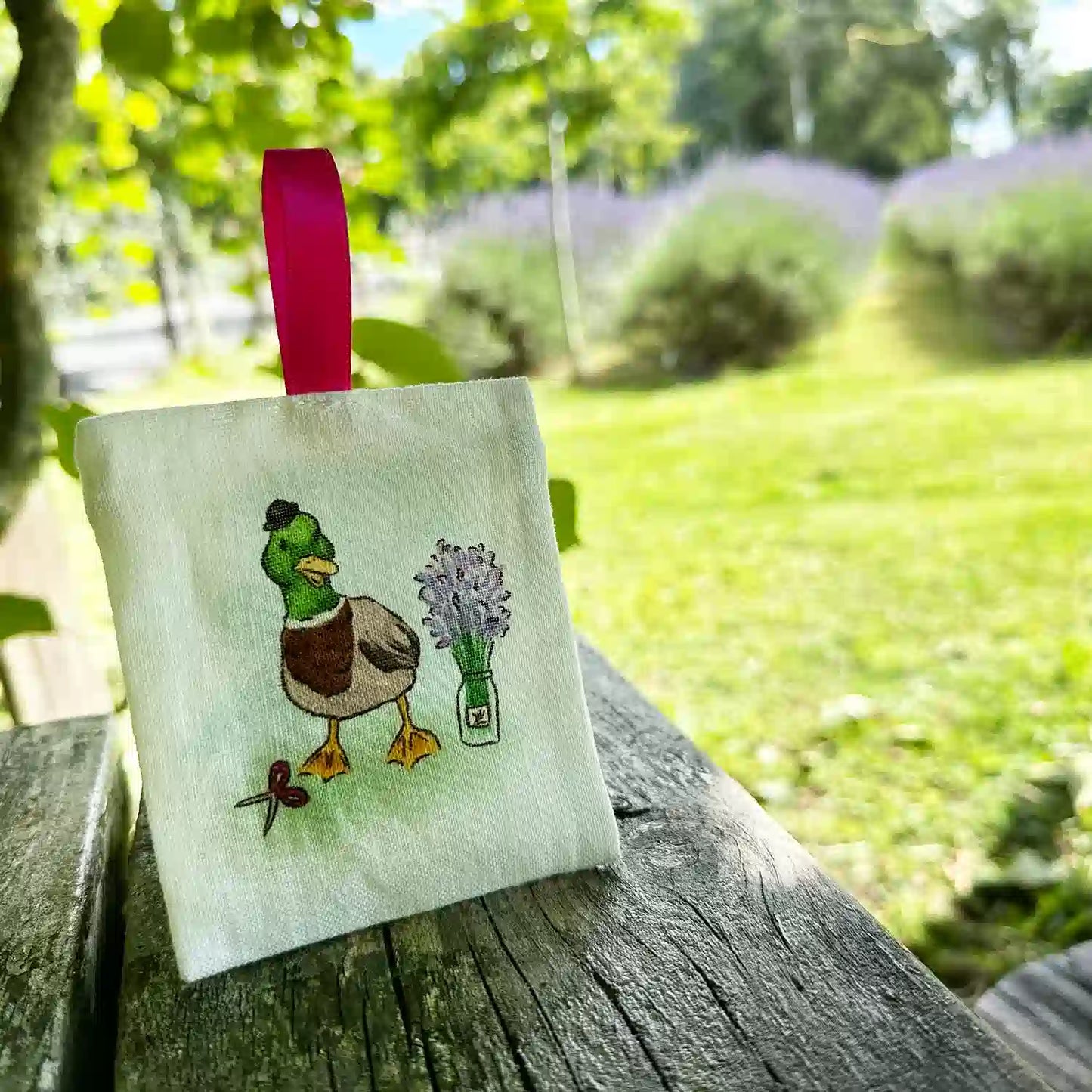 Farm animal duck linen sachets scented with a lavender aroma, set against the background of a lavender field at Lavender Backyard Garden.