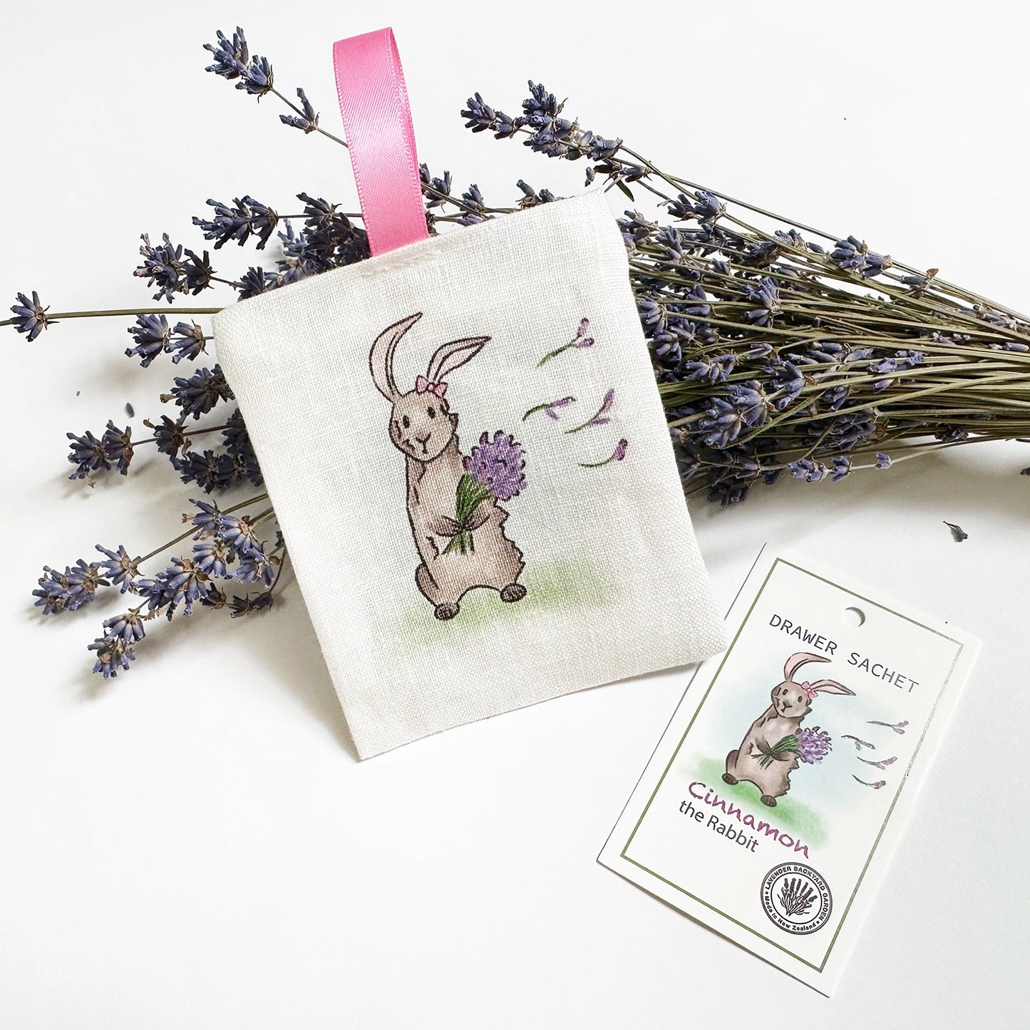 Farm animal rabbit linen sachet for drawer and wardrobe with a background of dried lavender flower bundles.