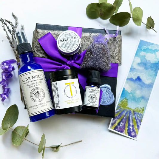 A beautifully arranged Get Well Soon Lavender Gift Set featuring sleep spray, soothing lavender chamomile tea, lavender-scented sleep balm made with essential oils, pure lavender essential oil, and a calming lavender sachet, all wrapped in a purple ribbon with a lavender field bookmark.