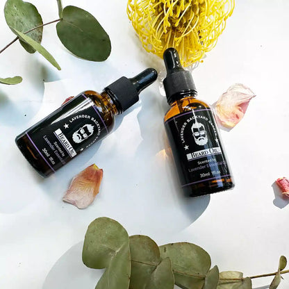 Close-up of Lavender Beard Oil for Men, scented by essential oils, with eucalyptus leaves and dried lavender in the background to highlight natural ingredients.