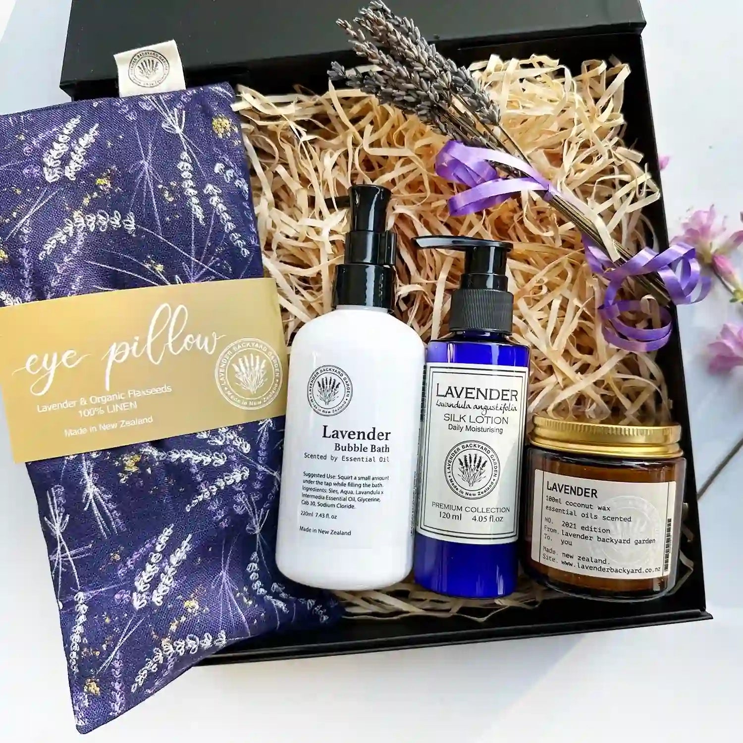 Deluxe Birthday Therapeutic Gift Basket with a lavender eye pillow, bubble bath, body lotion, and coconut wax candle, perfect for a relaxing and rejuvenating birthday treat.