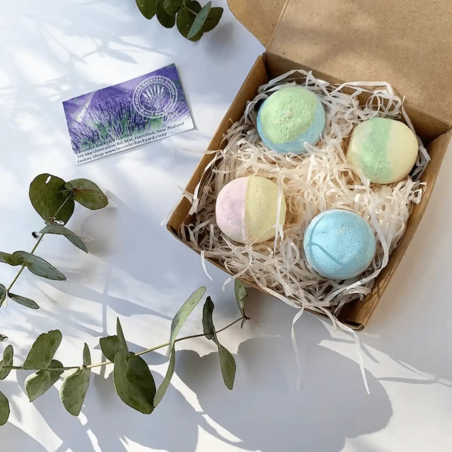 Gift set featuring four handmade bath bombs scented with lavender essential oil, elegantly packaged for a relaxing and aromatic bathing experience.