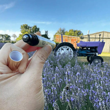 Close-up view of the Lavender Essential Oil Roller Blends for sleep with the lid open, showcasing the roller ball, set against a backdrop of lavender flowers at Lavender Backyard Garden, NZ.