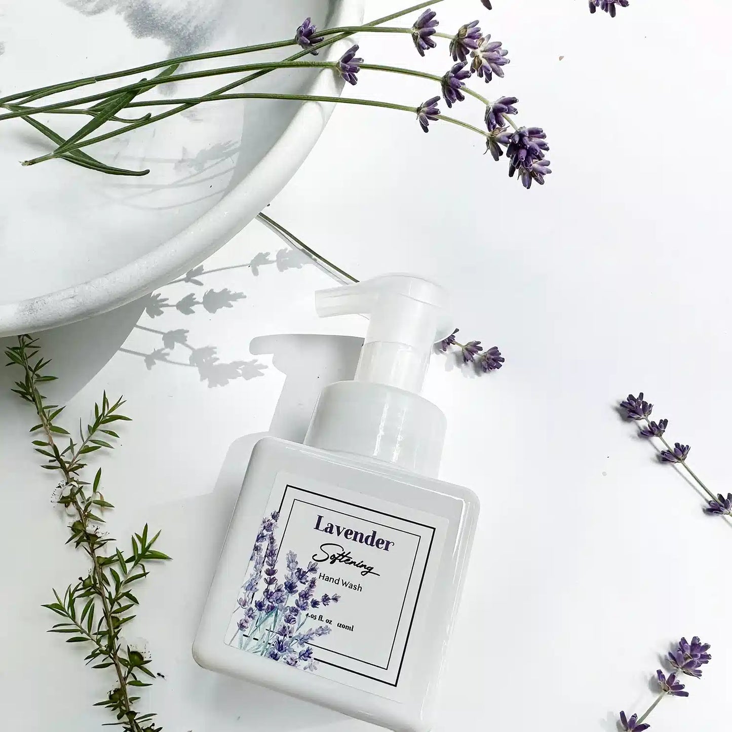 Lavender Foaming Hand Soap with a marble-patterned background and fresh lavender accents, emphasizing hand hygiene.