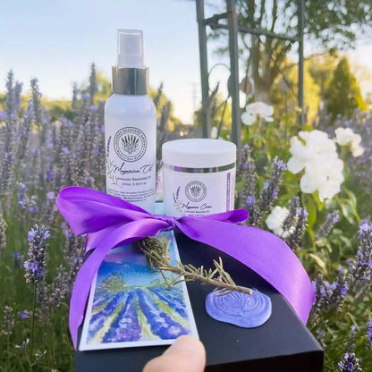 Lavender Magnesium Self-Care Gift Set for Ladies against a sunset lavender field with white roses at Lavender Backyard Garden, NZ.