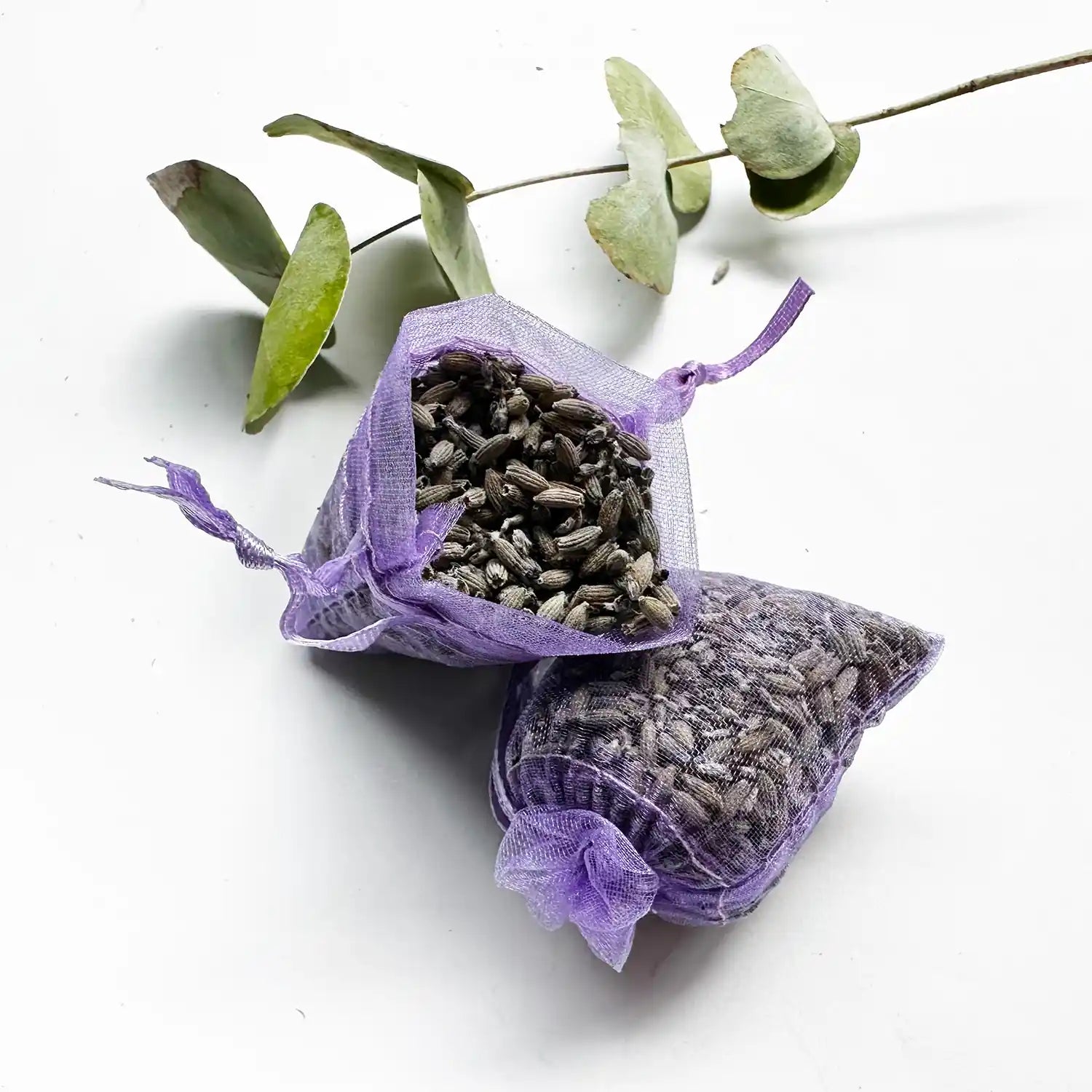 Purple lavender sachet for closet or drawer, with eucalyptus leaves background decor.