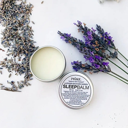 Lavender Sleep Balm blended with essential oils, featuring a calming lavender scent, with dried lavender flowers in the background.