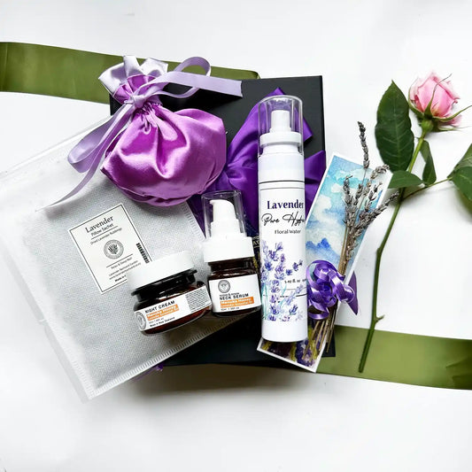 Manuka Honey Skin Care Gift Set featuring a Luxury Satin Lavender Sachet Bag, Lavender Manuka Honey Night Cream, Lavender Manuka Honey Neck Serum, Lavender Hydrosol Floral Water Face Toner, Sleeps Well Lavender Pillow Sachet, Mini Dried Lavender Flowers, and a Lavender Field Bookmark.