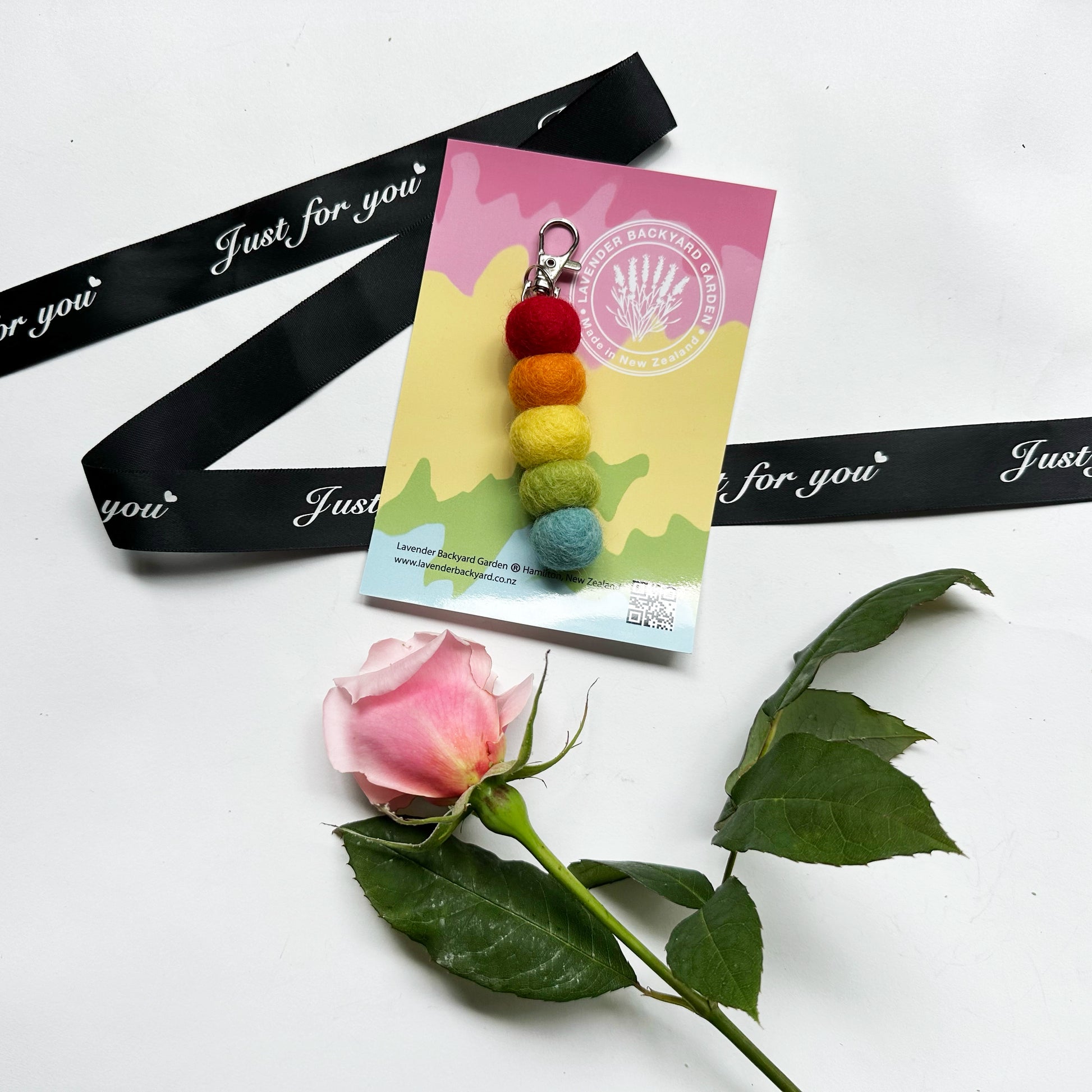 Colorful pastel felt ball keyring car diffuser, designed to hold essential oils for a calming scent in your vehicle.