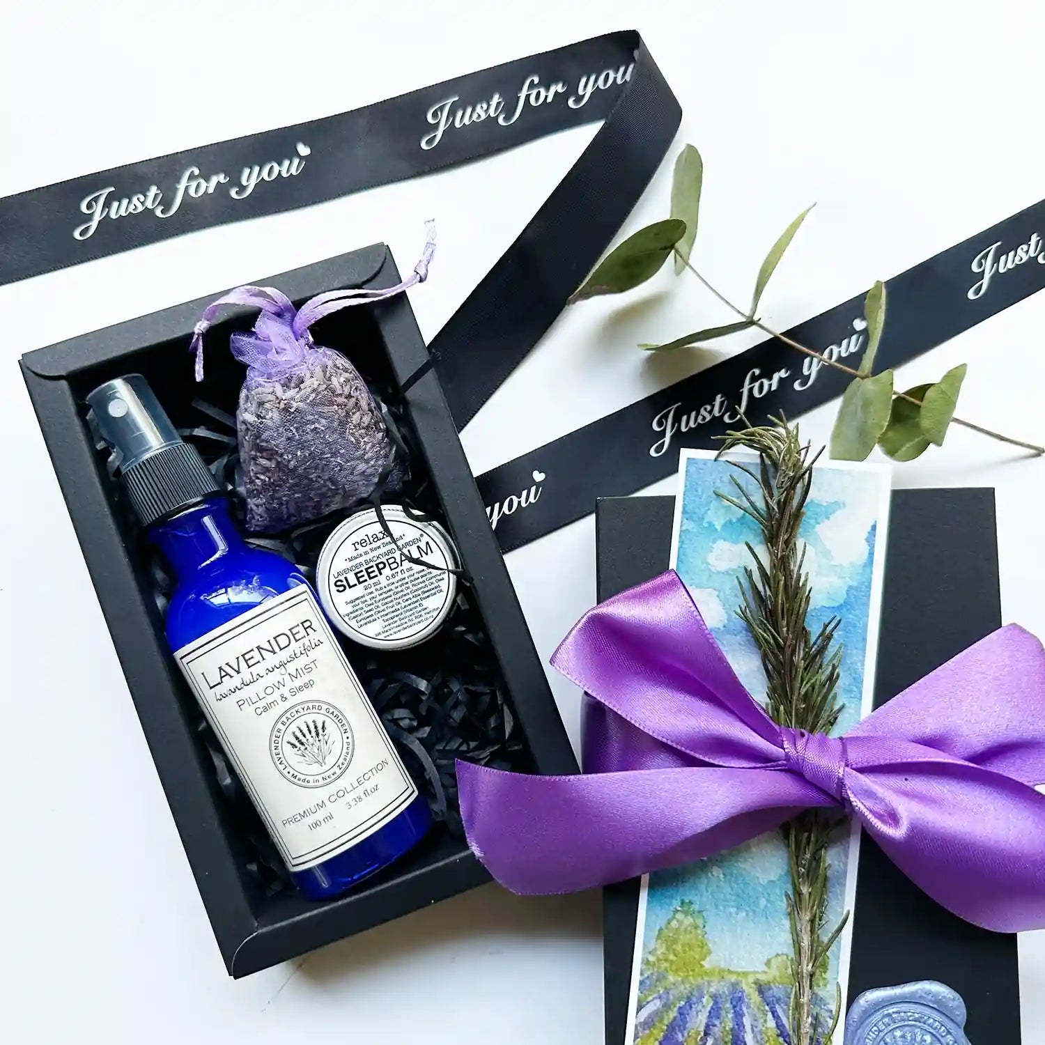 Peaceful Good Night's Sleepwell Gift Box featuring lavender pillow spray, sleep balm scented by essential oils, and a lavender sachet, all beautifully packaged to promote restful sleep and relaxation.