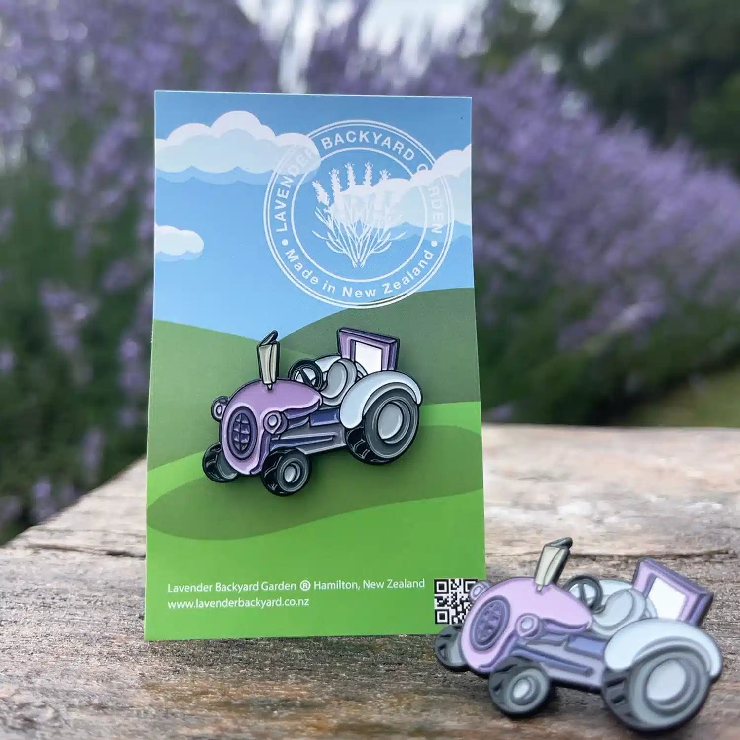 Purple tractor badge displayed with a lavender field background in a serene lavender backyard garden in New Zealand.