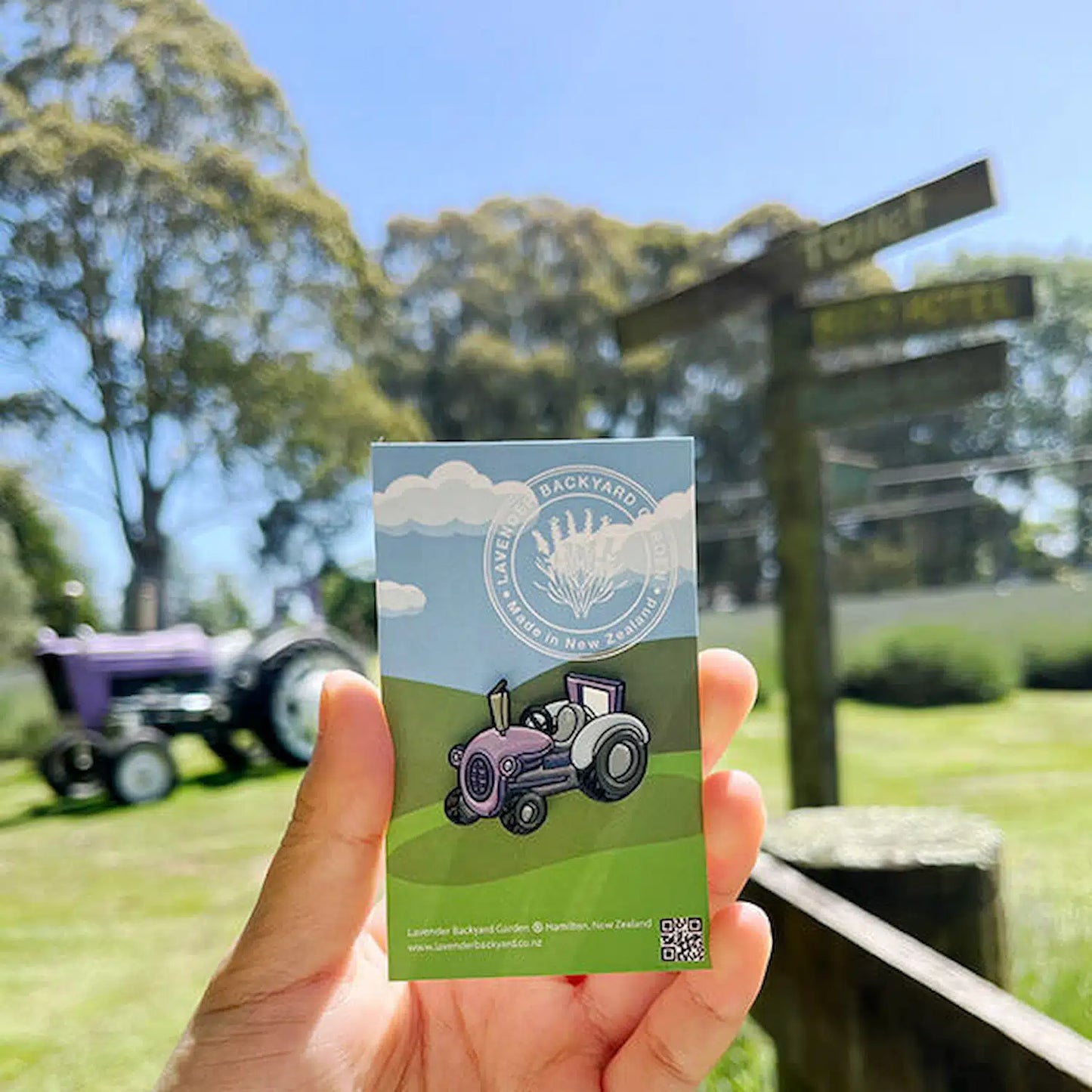 Purple tractor badge with a real purple tractor as the background, set in a lavender field.