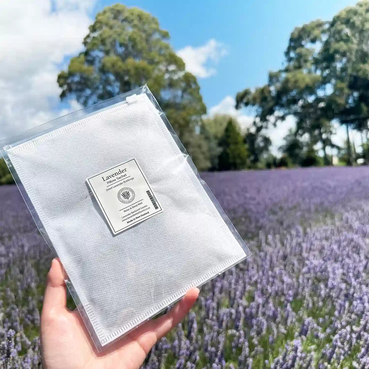 Sleeps Well Lavender Pillow Sachet, displayed with a calming lavender field background, creating a relaxing atmosphere.