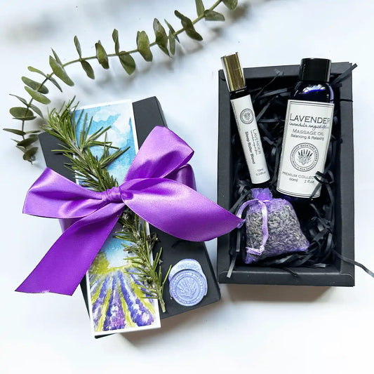 Sympathetic Get Well Gift Box featuring Sleep Roller Blends, lavender-scented massage oil, and a lavender sachet, elegantly wrapped with a purple ribbon and accompanied by a lavender field bookmark.