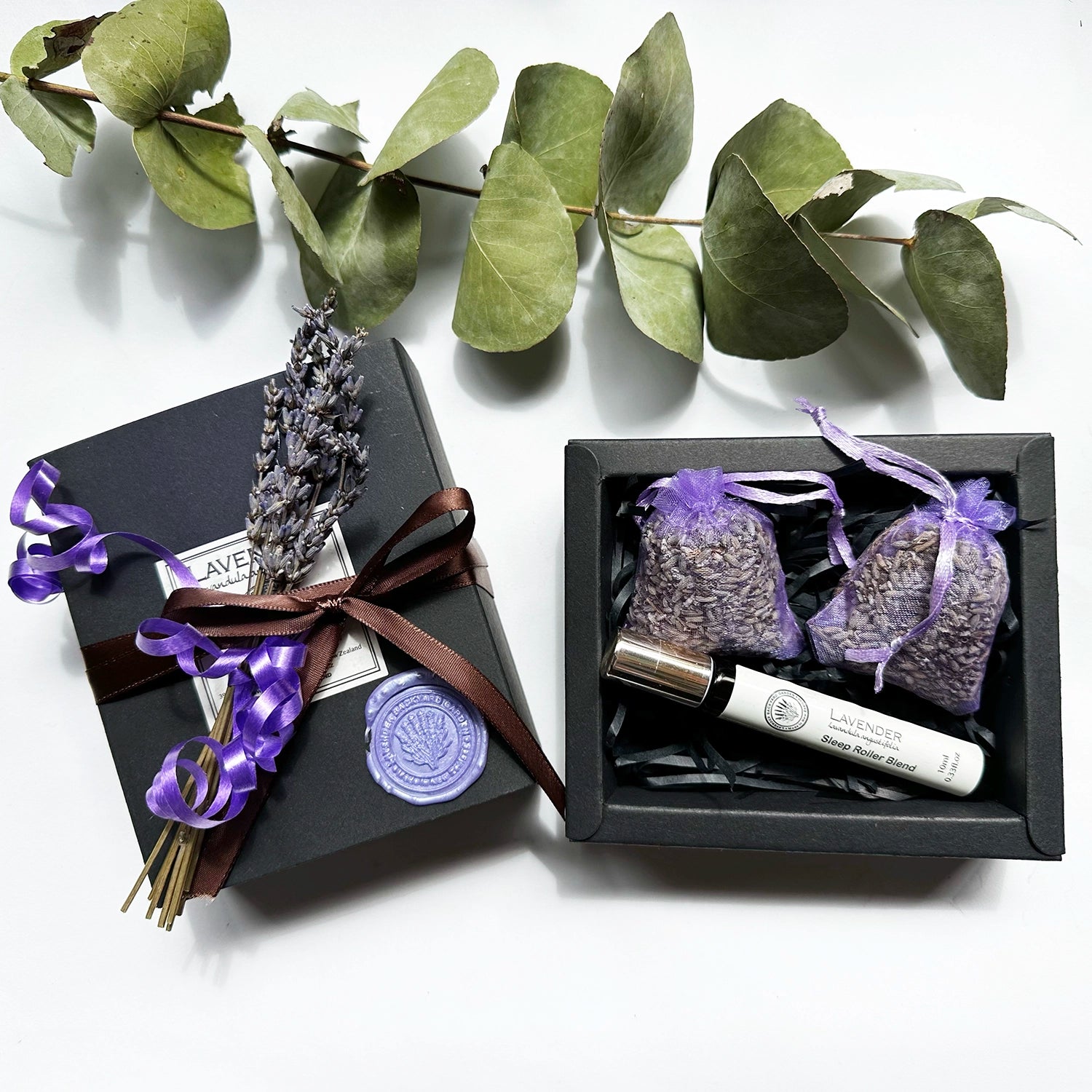 Thoughtful Presents for Her gift set featuring lavender sleep roller blends scented by essential oils and lavender sachets, elegantly wrapped in a stylish box with a delicate ribbon and a mini dried lavender flower.