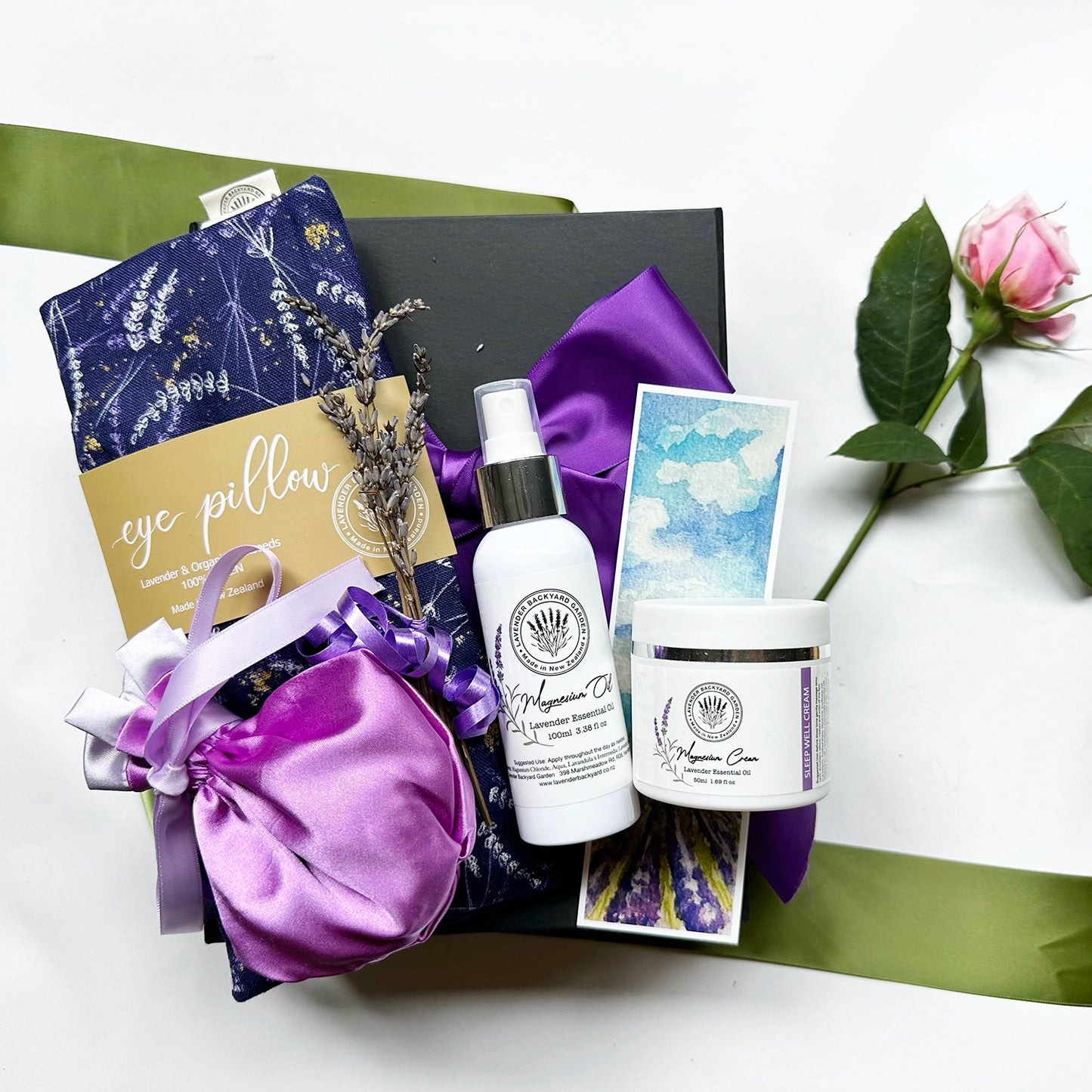 Violet Sleep Gift Set for Ladies featuring a Luxury Satin Lavender Sachet Bag, Organic Flaxseed Lavender Eye Pillow, Lavender Magnesium Oil Spray, Lavender Magnesium Sleep Cream, Mini Lavender Dried Flowers, and Lavender Field Bookmark for a calming sleep experience.